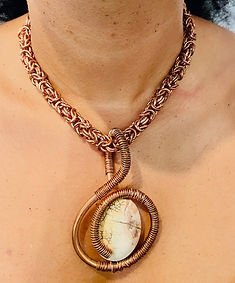 Handwoven copper chainmaille necklace with a wire-wrapped cabochon pendant
