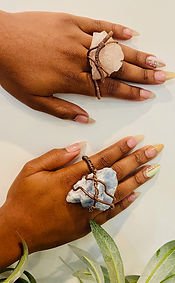 Wire-wrapped crystal rings worn on the hand